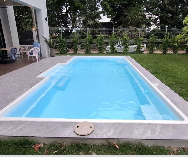 Completed Contemporary fiberglass pool viewed along the swimming area