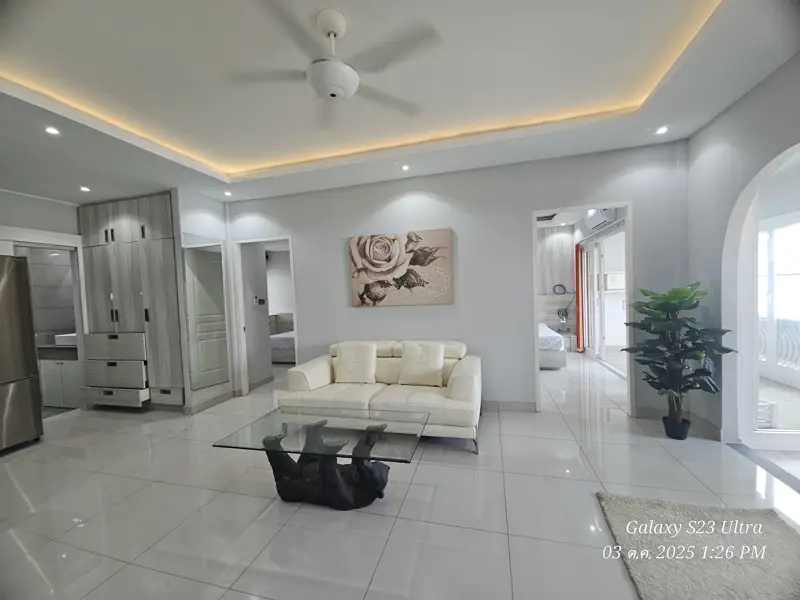 2 bed condo near Jomtien Beach with 3 swimming pools, 2 tennis courts, 2 sauna rooms, a fitness center, a playground, restaurants, and laundry service.