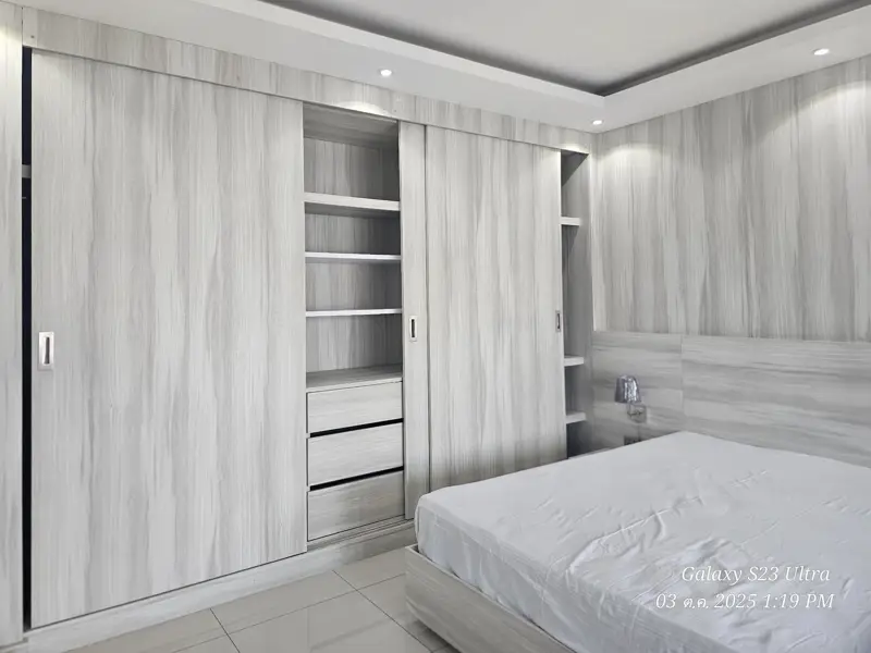 2 bed condo near Jomtien Beach with 3 swimming pools, 2 tennis courts, 2 sauna rooms, a fitness center, a playground, restaurants, and laundry service.