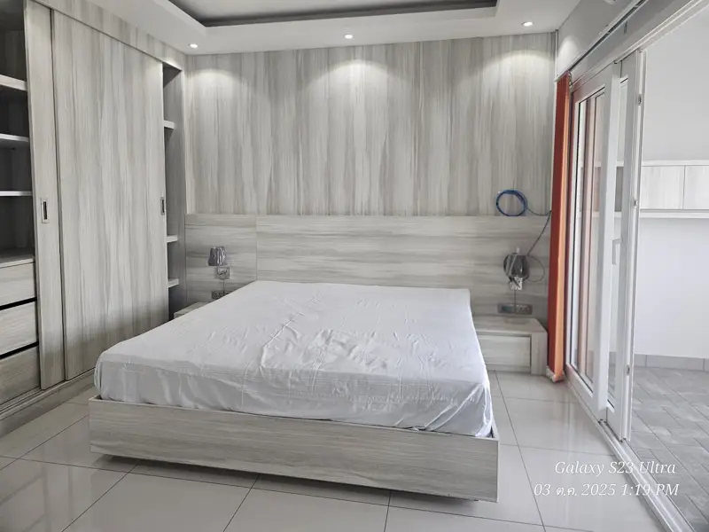 2 bed condo near Jomtien Beach with 3 swimming pools, 2 tennis courts, 2 sauna rooms, a fitness center, a playground, restaurants, and laundry service.
