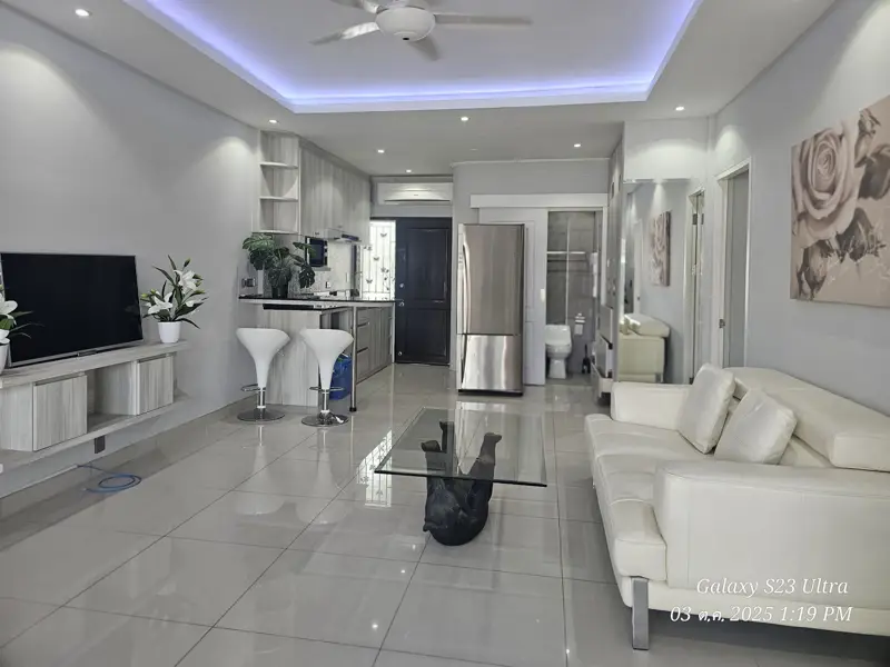 2 bed condo near Jomtien Beach with 3 swimming pools, 2 tennis courts, 2 sauna rooms, a fitness center, a playground, restaurants, and laundry service.