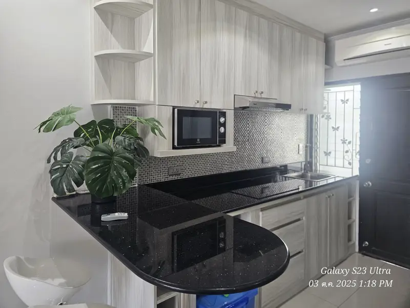 2 bed condo near Jomtien Beach with 3 swimming pools, 2 tennis courts, 2 sauna rooms, a fitness center, a playground, restaurants, and laundry service.