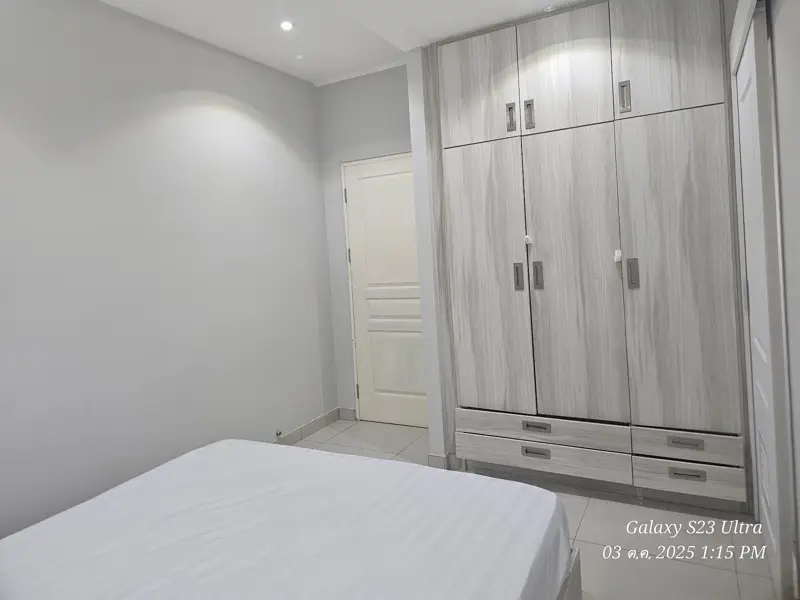 2 bed condo near Jomtien Beach with 3 swimming pools, 2 tennis courts, 2 sauna rooms, a fitness center, a playground, restaurants, and laundry service.