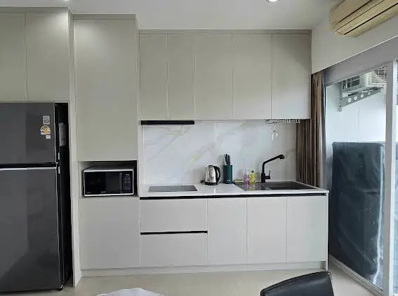  1 bed sea view condo Wongamat with facilities such as a swimming pool, fitness center, BBQ area, and on-site restaurant.