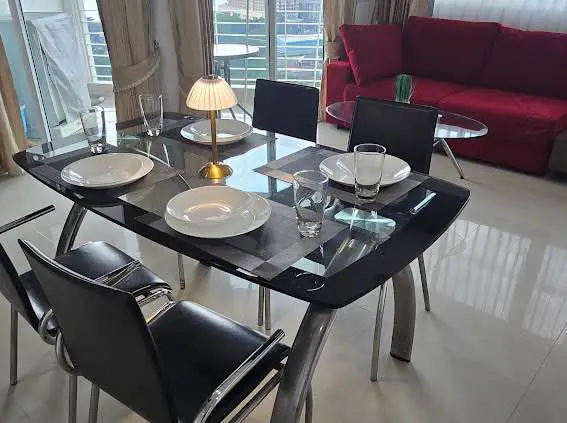  1 bed sea view condo Wongamat with facilities such as a swimming pool, fitness center, BBQ area, and on-site restaurant.