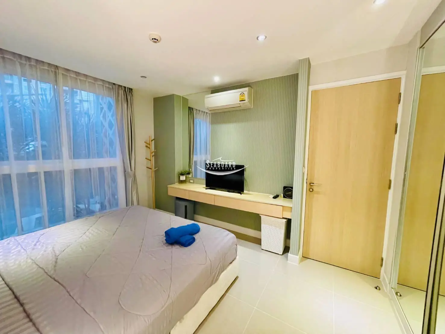 Comfortable  Bed and Well-Lit Bedroom Space