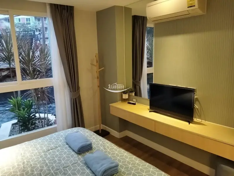 Cozy Bedroom with Fitted TV Console and Large Window