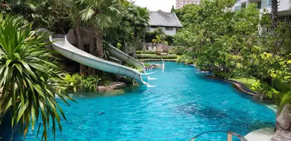 Resort Pool with Waterslide & Tropical Landscaping
