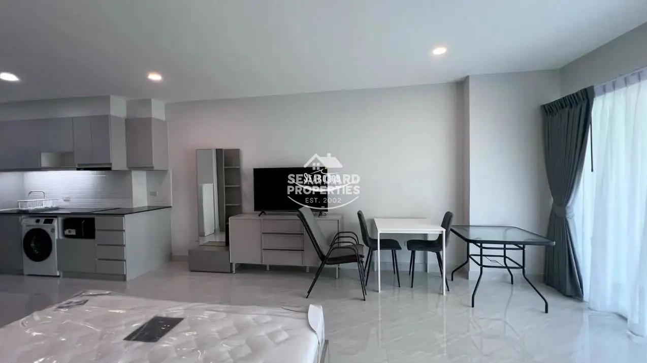 View Talay 5 D Condominium Jomtien Studio Living Space & Wall-Mounted TV Area | Seaview Apartment for Sale & Rent